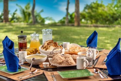 a table with a plate of food on it at Villa Karamoja in Koggala