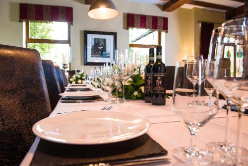 a long table with glasses and wine bottles on it at Blackwell House in Banbridge