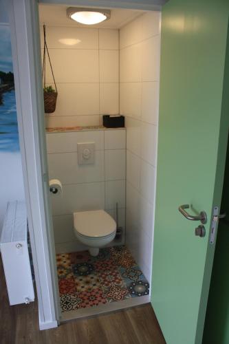 a bathroom with a toilet in a room at Bed & Breakfast Aalsmeer in Aalsmeer