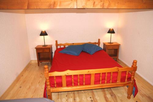 a bedroom with a wooden bed and two night stands at Village de gites Lapeyre in Lapeyre