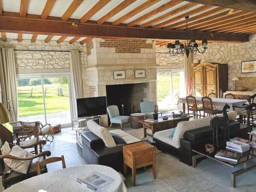 a living room filled with furniture and a fireplace at La ferme aux grenouilles in Saint-Josse