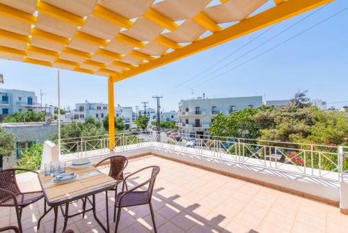 a patio with a table and chairs on a balcony at Estia Tinos in Tinos