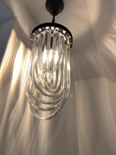 a large glass light hanging from a ceiling at Seveniger Mühle in Sevenig
