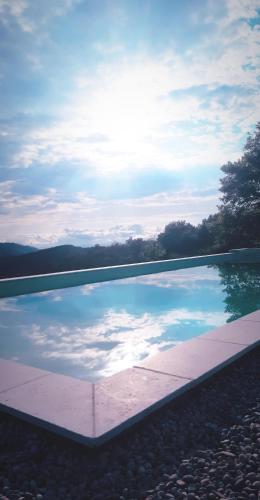 une piscine d'eau avec vue sur le ciel dans l'établissement L ' AMIRADOU, à Félines-sur-Rimandoule