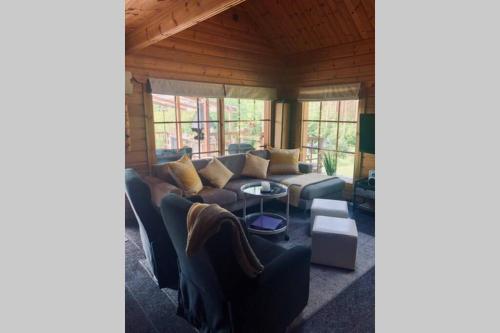 a living room with a couch and a table at Villa Kumpare in Lohja