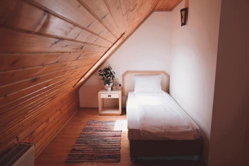 a small bedroom with a bed and a table at Marie Chalet in Breaza