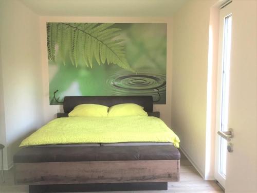 a bedroom with a bed with a painting on the wall at SALUS Spreewald - Erholung & Natur - in Kolonie