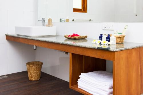 a bathroom with a sink and a counter with towels at The Notary's House in Makandura