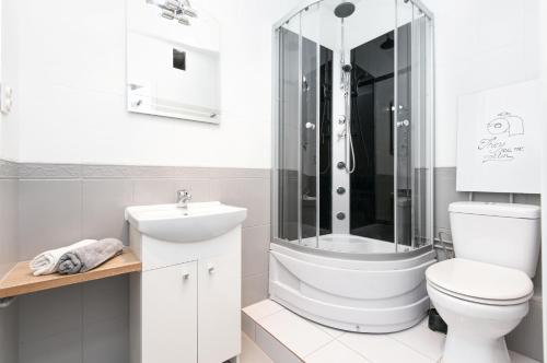 y baño con ducha, aseo y lavamanos. en Rooms4Less, en Gdansk