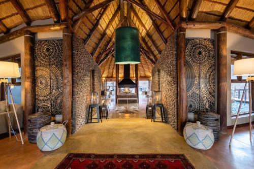 a room with wooden walls and a ceiling with a green bucket at Hoodia Desert Lodge in Sesriem