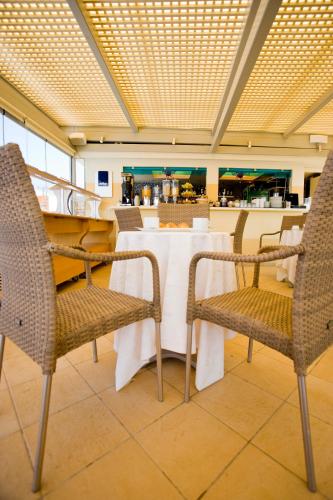 a restaurant with a table and chairs and a counter at Princess Of Naxos in Naxos Chora