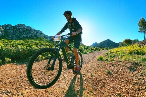 a man riding a bike on a dirt road at Le Panorama des Alpilles in Aureille