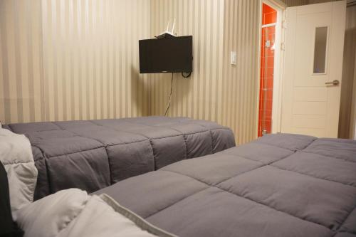 Letto o letti in una camera di Mama Guesthouse Myeongdong