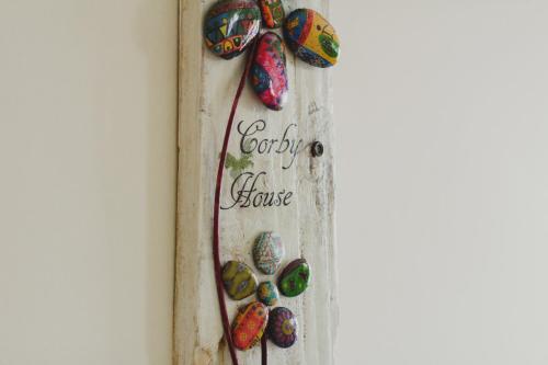 a painting of easter eggs on a wall with a bow at corby house in Ardara