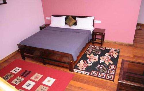 A bed or beds in a room at Lotus The Cottages