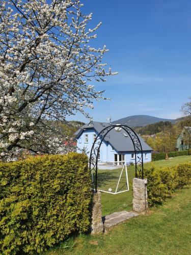 a swing set in a yard with a house at BLUE PENSiON in Svoboda nad Úpou