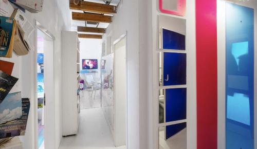 a hallway with a red white and blue wall at @friends by CitySurfer in Hamburg