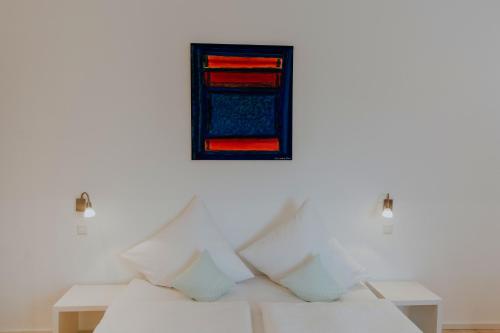 a white room with a bed and a window at Hotel Barbarossa Karlsruhe Stadtmitte in Karlsruhe