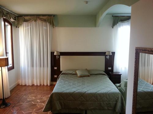 a bedroom with a bed and a mirror in it at Hotel Sant'Antonin in Venice