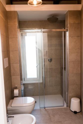 a bathroom with a shower with a toilet and a sink at Cava Rossa in Favignana