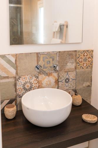 a white bowl sink on a counter in a bathroom at Cava Rossa in Favignana