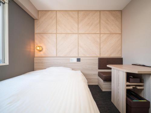 a small bedroom with a bed and a desk at Super Hotel Gotenba - 1 in Gotemba
