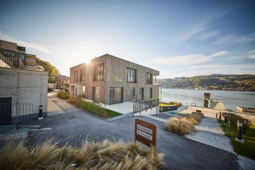 a house with a view of a body of water at Hermitage Apartments in Maria Wörth