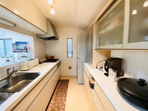 a kitchen with a sink and a counter top at Naotoko Minpaku #HG1 in Tokyo