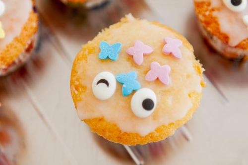 a cupcake with eyes and bows on top of it at Appartementhaus EifelAdventures in Berlingen