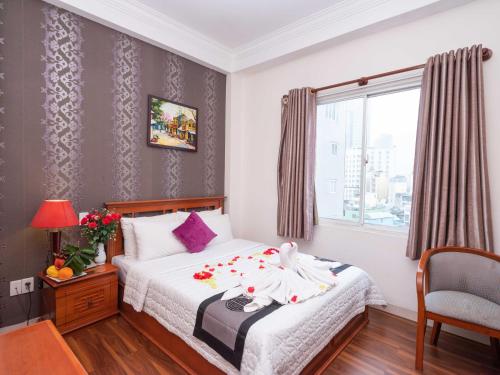 a bedroom with a bed and a window at Hong Hac Hotel in Ho Chi Minh City