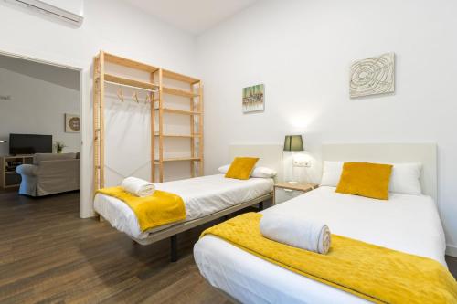 1 dormitorio con 2 camas y sala de estar en San Isidoro Cathedral Oasis by Valcambre, en Sevilla