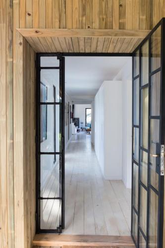 a hallway with a glass door in a house at Casa Flor in Punta del Este