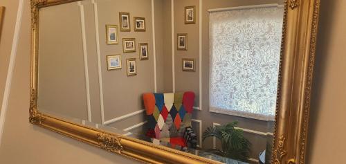 a mirror in a room with a window and a curtain at Afonso Galo Guest Apartments II in Almada