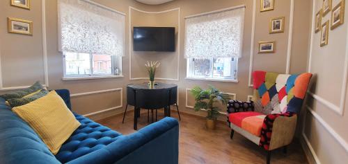 a living room with a blue couch and two chairs at Afonso Galo Guest Apartments II in Almada