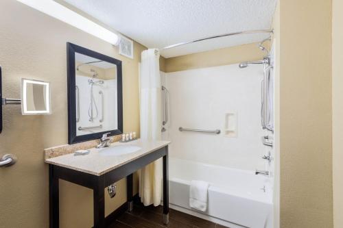 a bathroom with a sink and a shower and a tub at La Quinta Inn & Suites - New River Gorge National Park in Summersville