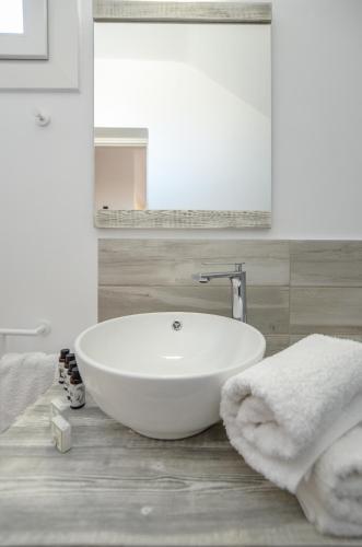 a bathroom with a white sink and a mirror at Orkos Naxian Wave 2 in Mikri Vigla