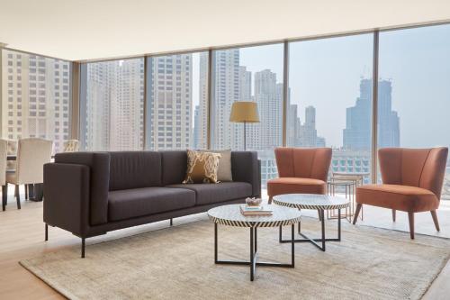 a living room filled with furniture and a large window at Sonder at JBR The Walk in Dubai