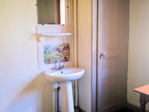 a bathroom with a white sink next to a door at Le Chamoniard Volant in Chamonix-Mont-Blanc