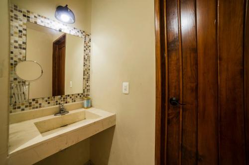 a bathroom with a sink and a mirror at HOTEL XIADANI Restaurante, Temazcal & Spa in Tlaxcala de Xicohténcatl