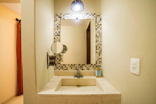 a bathroom with a sink and a mirror at HOTEL XIADANI Restaurante, Temazcal & Spa in Tlaxcala de Xicohténcatl