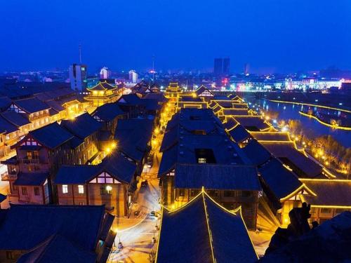 a view of a city at night with lights at 7Days Inn Qingzhou Pingzhangfu Store in Weifang