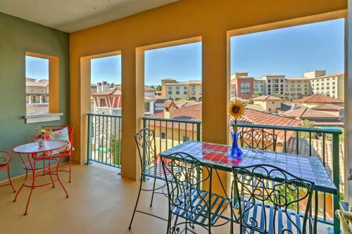 a balcony with a table and chairs and windows at Lake Las Vegas Condo with Balcony, Resort Amenities! in Henderson