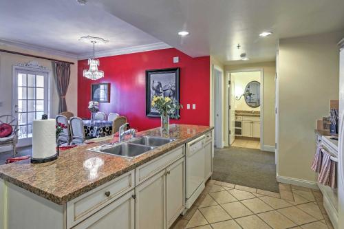 - une cuisine avec un évier et un mur rouge dans l'établissement Luxury Lake Las Vegas Condo with Resort Amenities!, à Las Vegas