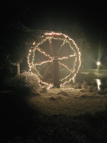 a large circle of lights is lit up at night at Alexander's Lodge in Ashford