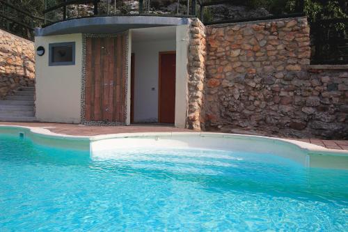 a large swimming pool with a door in a building at Hotel Isola Verde in Nago-Torbole