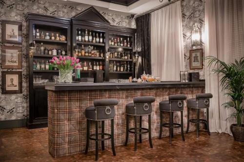 a bar with stools in a room at NH Collection Colón Valencia in Valencia