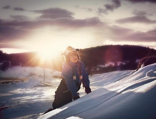 a young child is walking in the snow at Can Congost in Sort
