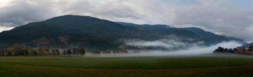 a misty field with a mountain in the background at Can Congost in Sort