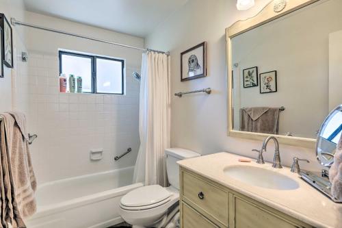 a bathroom with a sink and a toilet and a mirror at Flagstaff Townhome with Deck 10 Mi to Walnut Canyon in Flagstaff