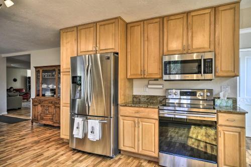 a kitchen with wooden cabinets and stainless steel appliances at Charming Kelso Home with Proximity to Cowlitz River! in Kelso
